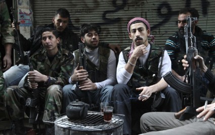 Free Syrian Fighters drink tea as they rest in Aleppo's district of Salaheddine